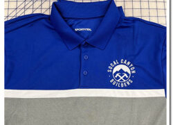 Blue polo shirt with an embroidered white business logo Blue polo shirt with an embroidered white business logo