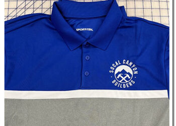 Blue polo shirt with an embroidered white business logo