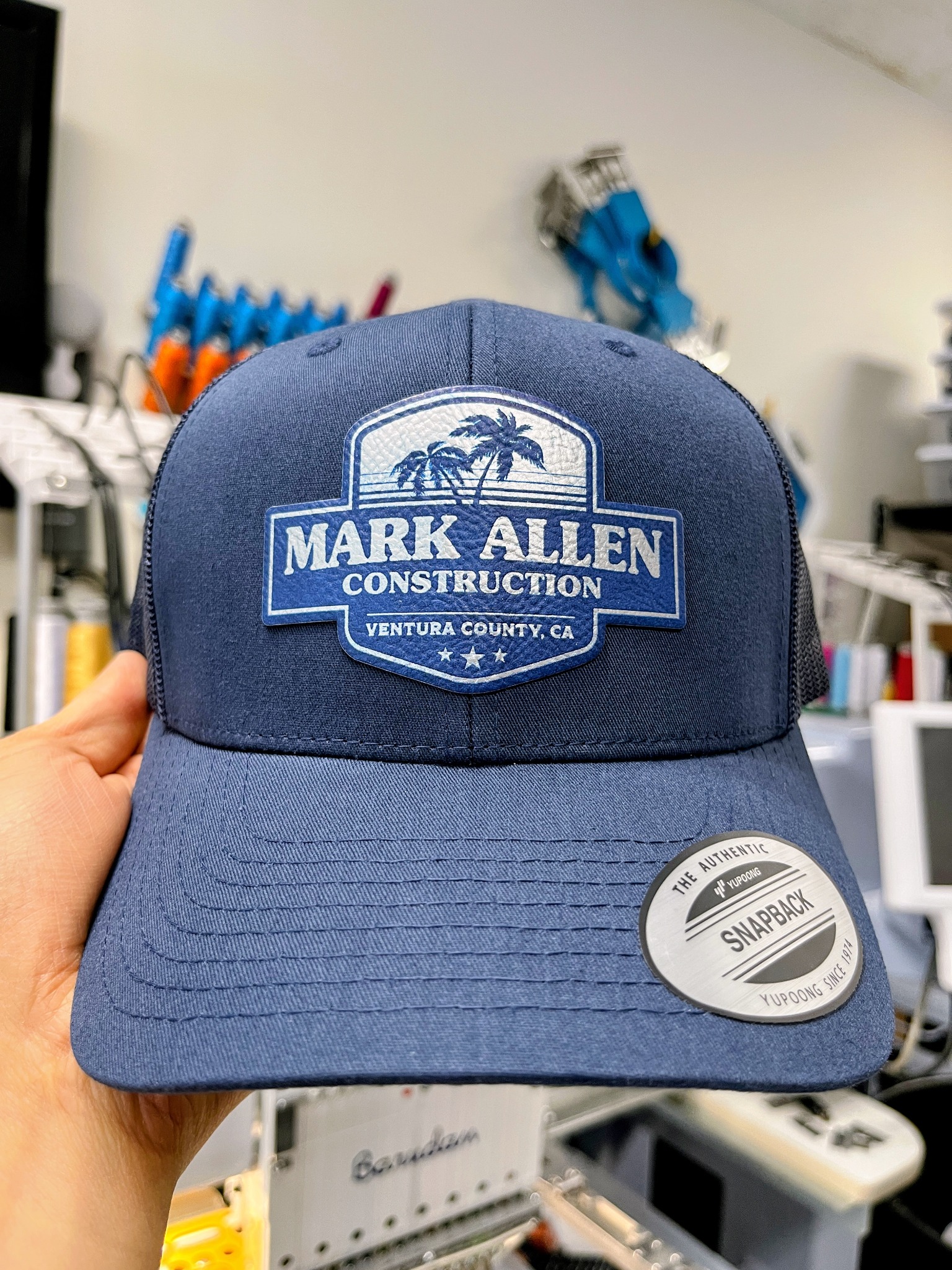 Navy Mark Allen Construction hat with a blue and white logo patch
