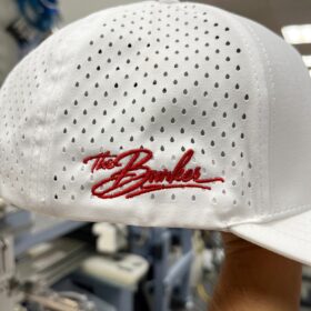 Red The Bunker script embroidered on the side of a white perforated hat