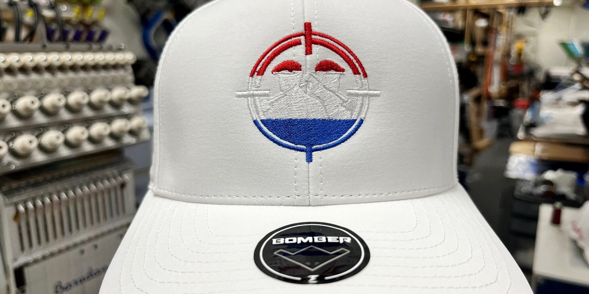 White hat with red white and blue embroidered logo at SpectraColor in Simi Valley