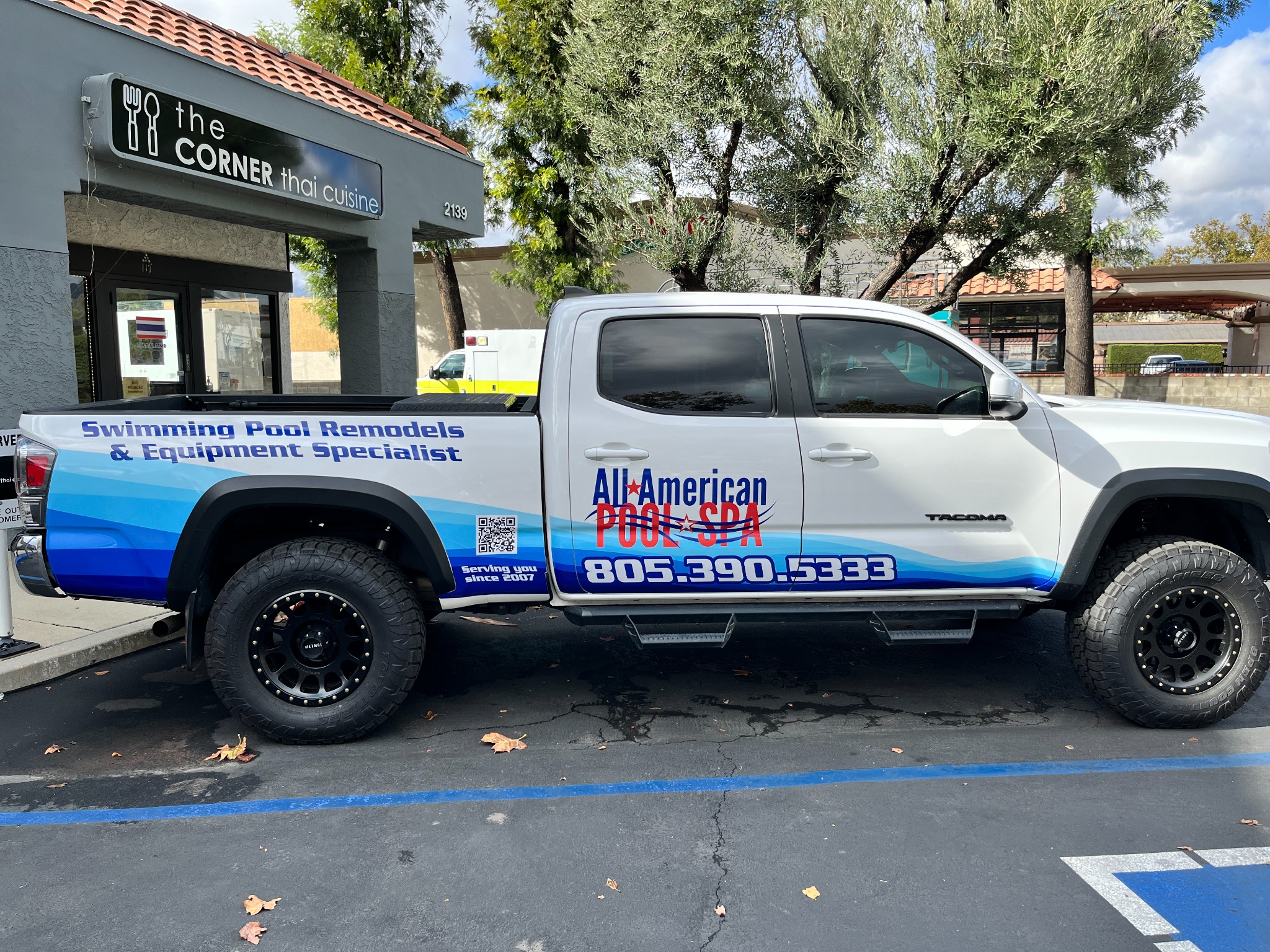 All American Pool & Spa truck graphics by SpectraColor All American Pool & Spa Toyota Tacoma with blue wave vehicle graphics, business logo and truck lettering installed by SpectraColor in Simi Valley