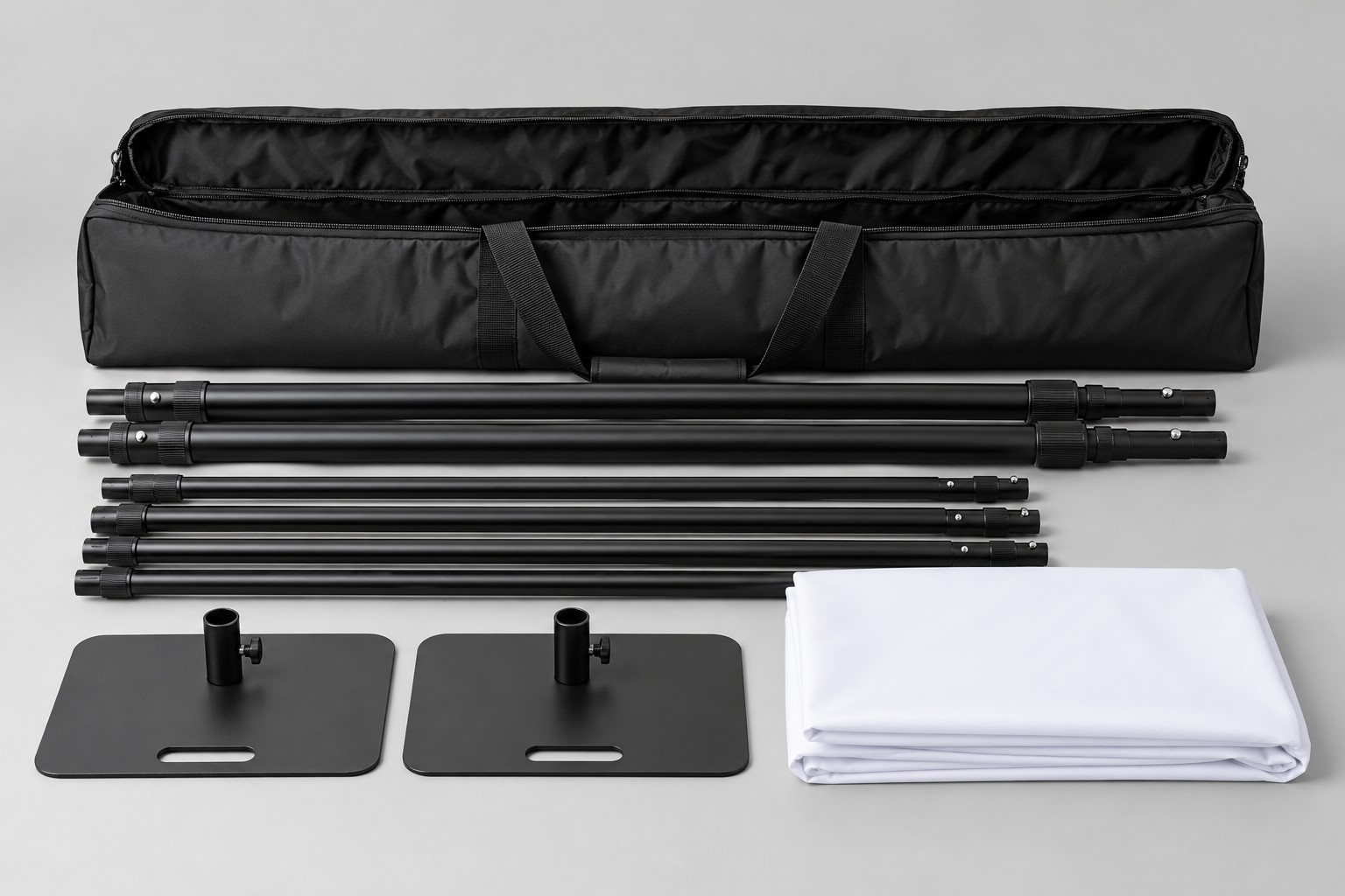 Disassembled backdrop stand with base feet, folded fabric and carrying bag Disassembled backdrop stand with base feet, folded fabric and carrying bag