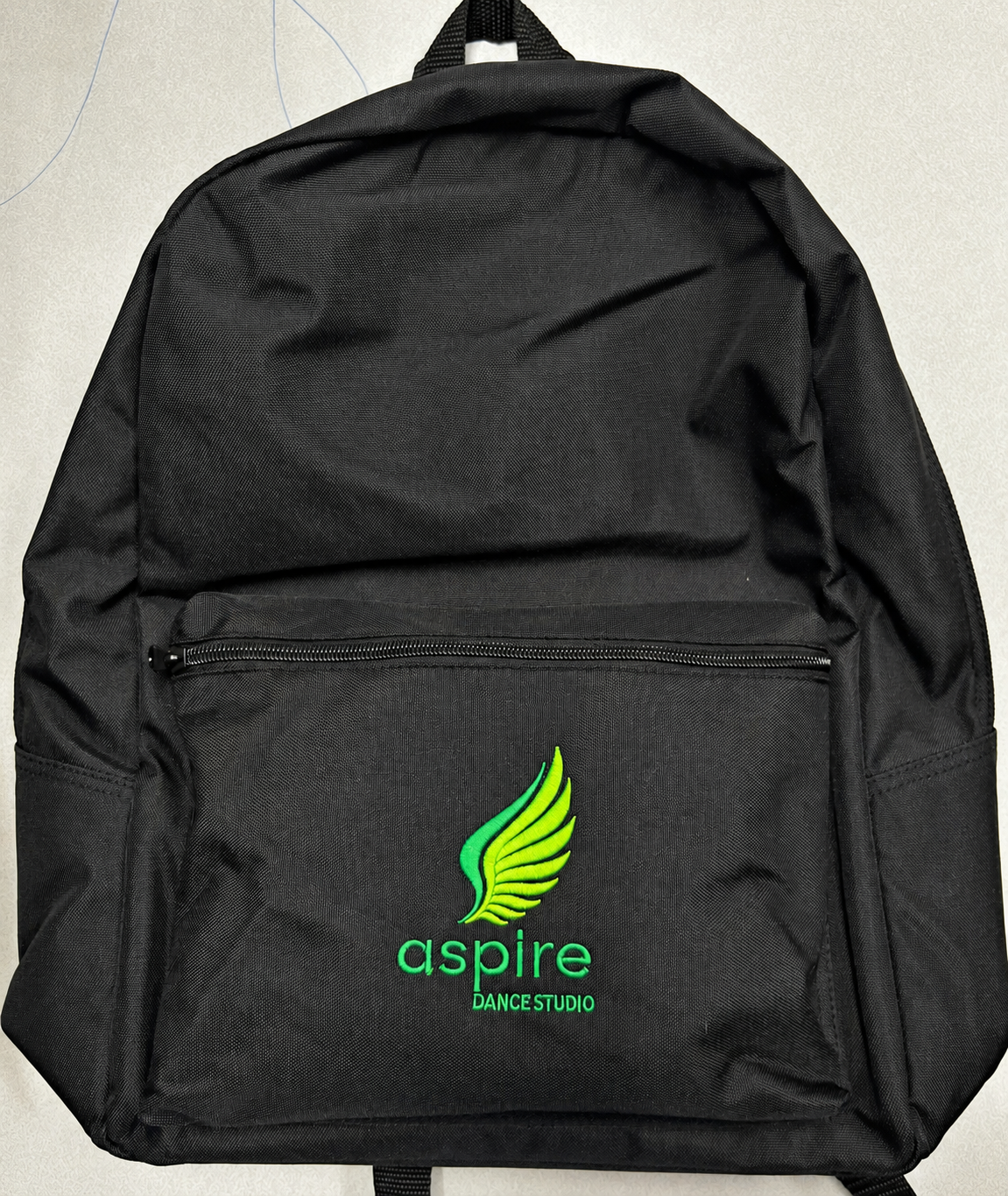 Black backpack with green Aspire Dance Studio embroidery by SpectraColor