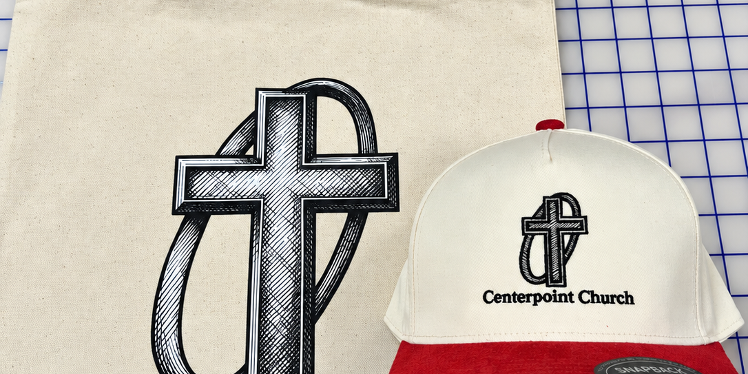 Natural-color Center Point Church tote bag beside a cream and red embroidered hat