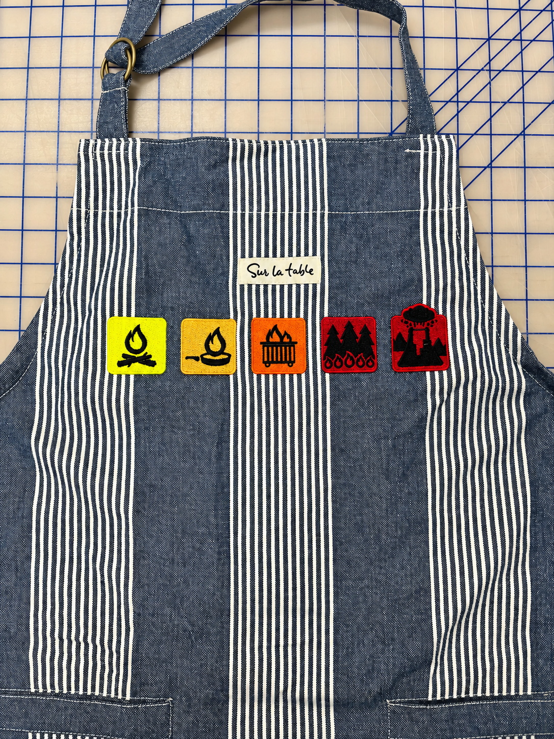Striped apron with five colorful embroidered designs by SpectraColor in Simi Valley