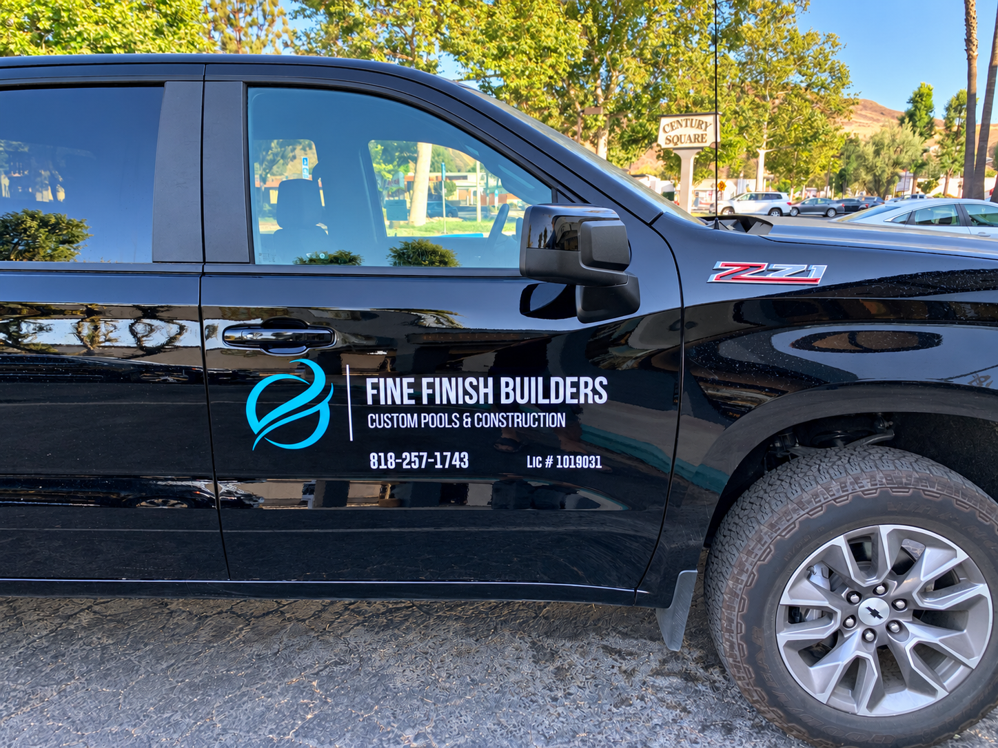 Black contractor pickup with Fine Finish Builders turquoise logo and white door lettering by SpectraColor in Simi Valley.
