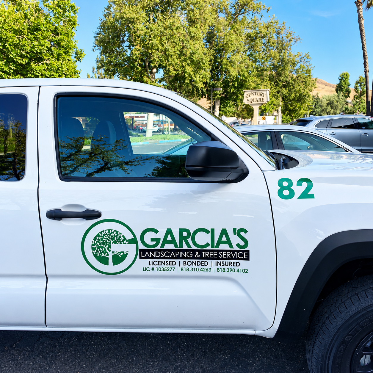 Garcia’s Landscaping green logo and contact lettering on a white pickup door.