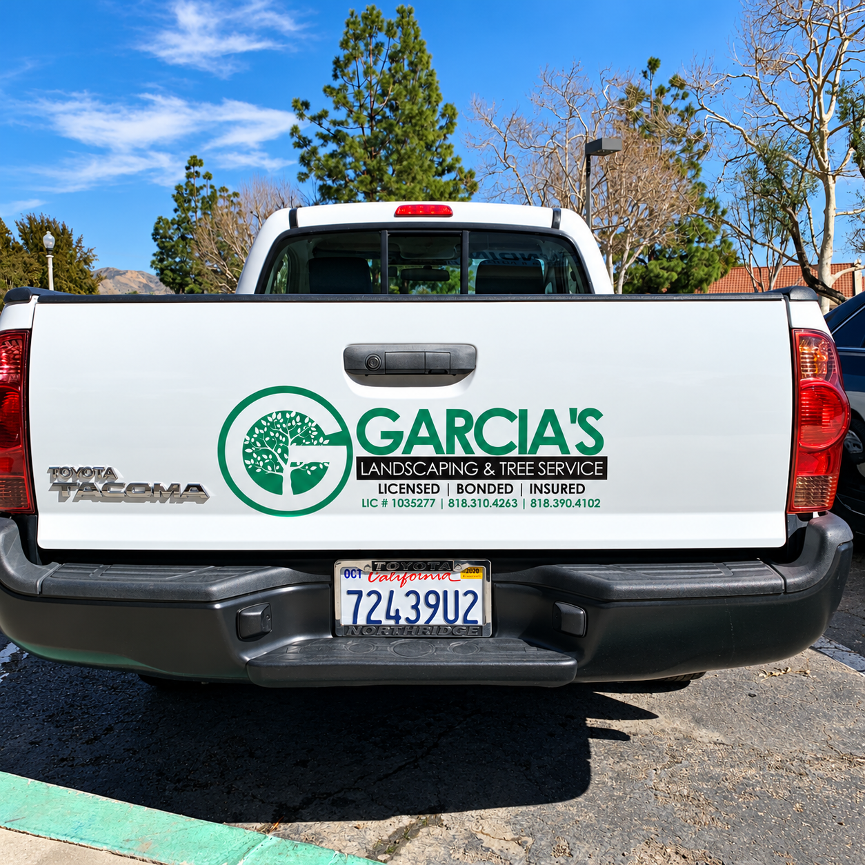Garcia’s Landscaping logo and lettering on the tailgate of a white Toyota Tacoma.