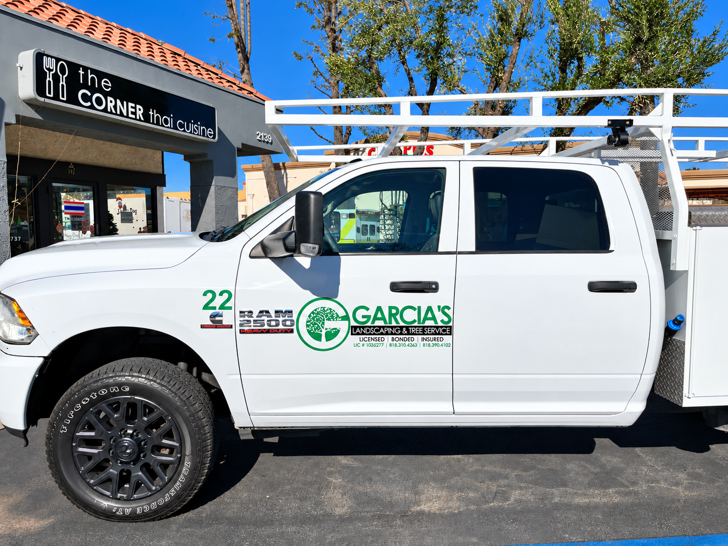 White Ram work truck with Garcia’s Landscaping green logo and company lettering by SpectraColor.