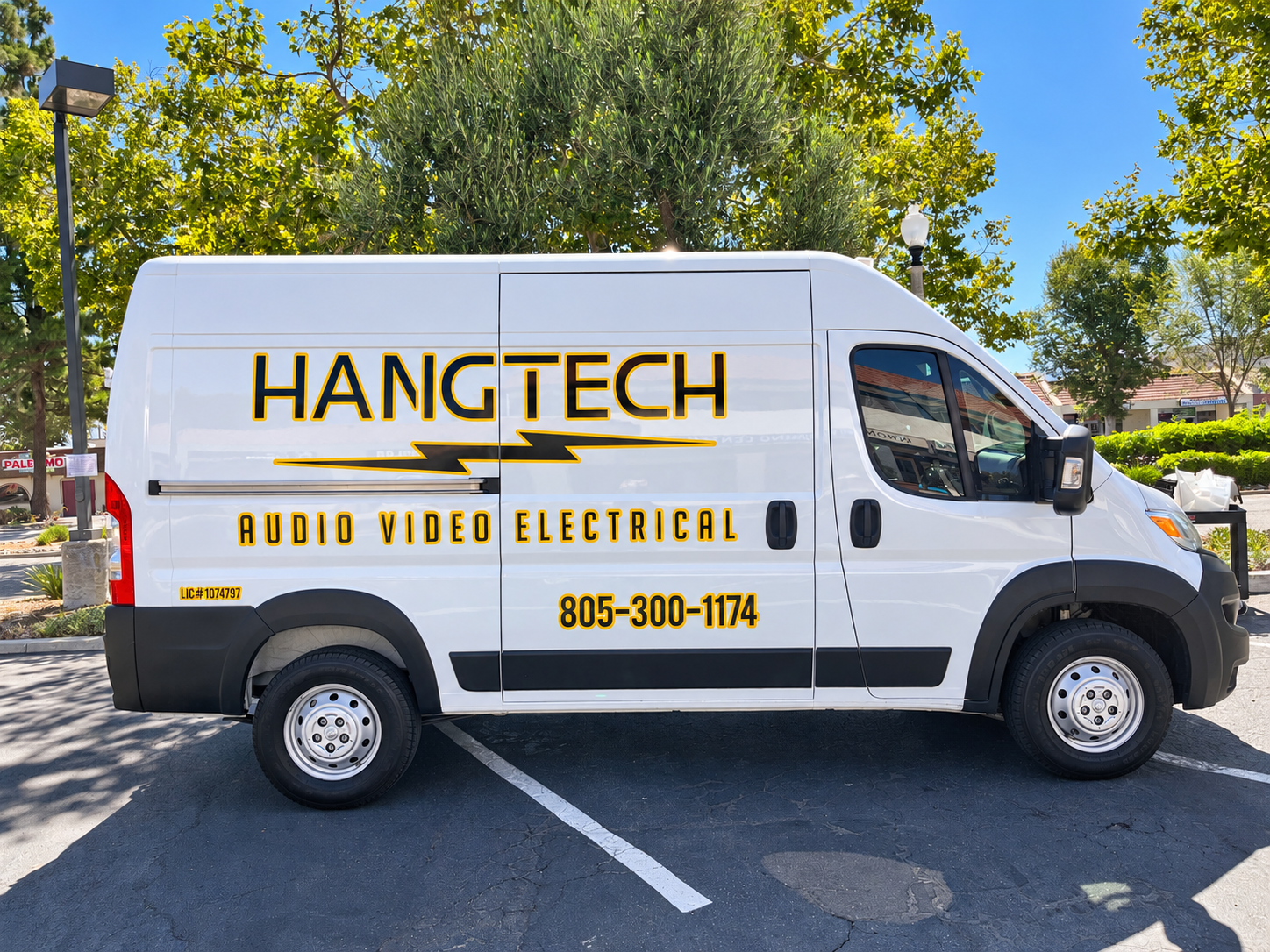 Passenger-side Hang Tech fleet van graphics on a white Ram ProMaster