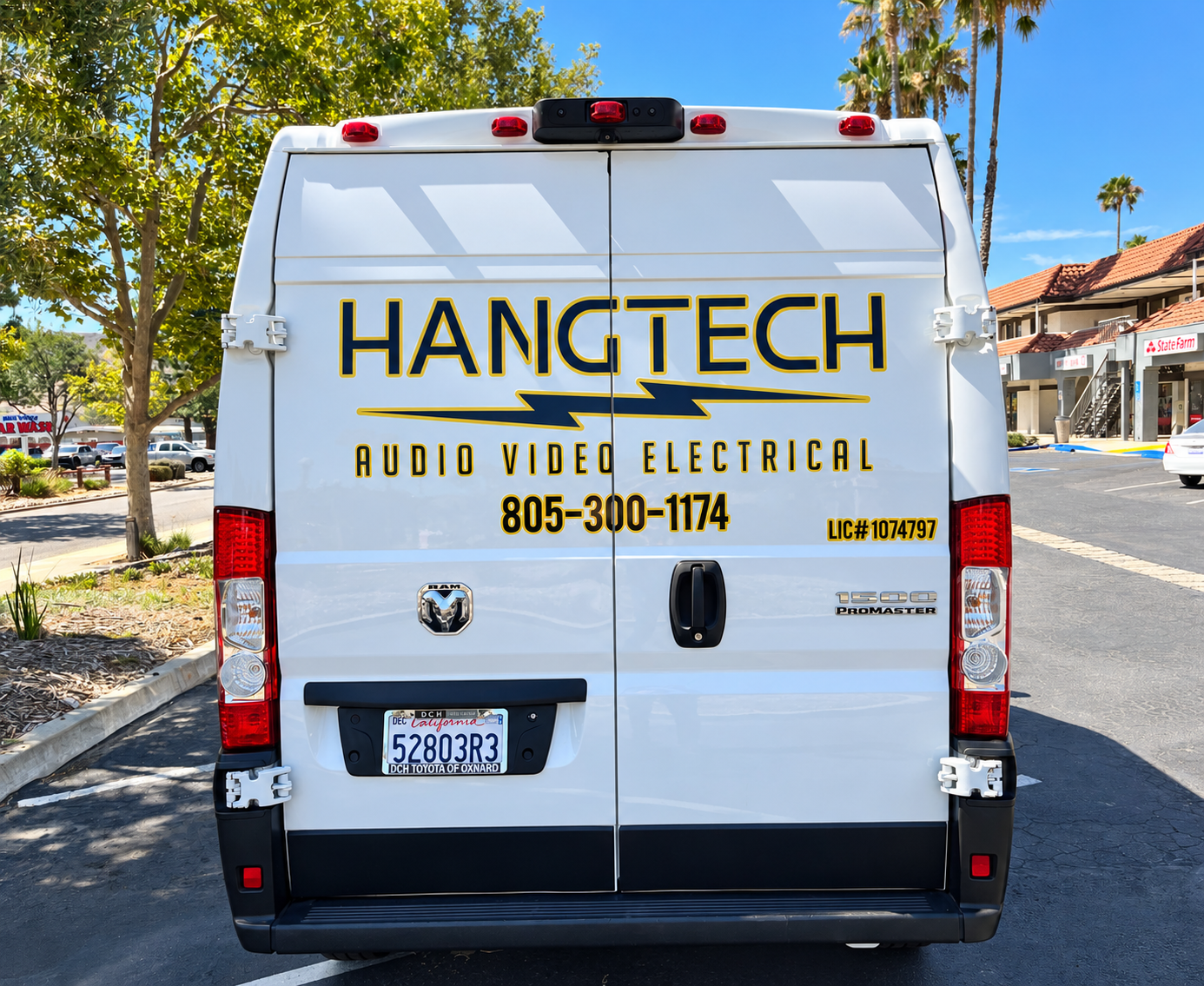 Rear doors of Hang Tech Ram ProMaster with black and gold business lettering and contact details