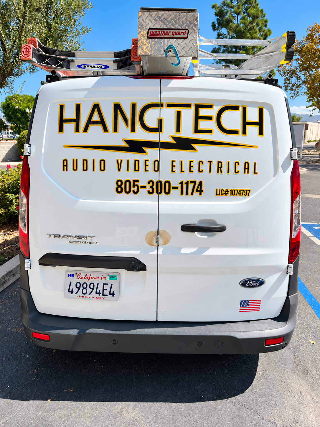 Rear view of Hang Tech Ford Transit Connect with company logo services and phone number lettering