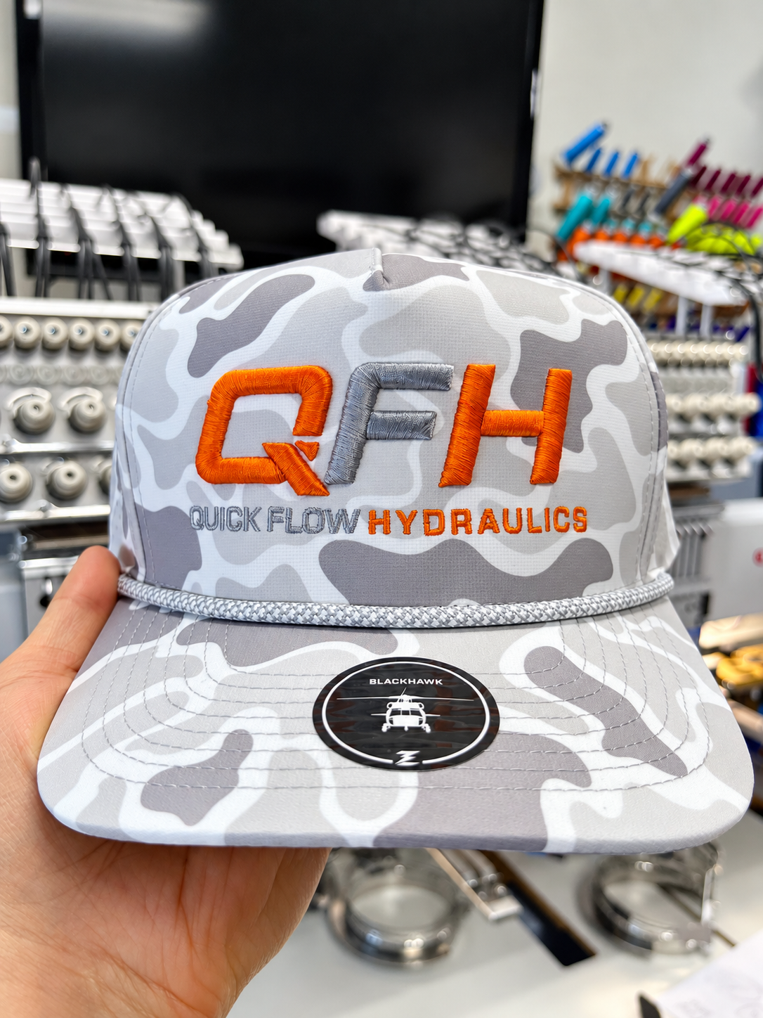 Light camouflage rope hat with orange and gray raised QFH logo embroidery