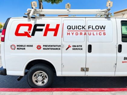 Quick Flow Hydraulics van lettering — driver side White Quick Flow Hydraulics work van with red and black QFH logo and service lettering