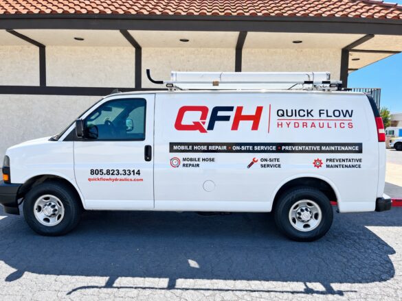 Quick Flow Hydraulics van lettering — driver side White Quick Flow Hydraulics work van with red and black QFH logo and service lettering