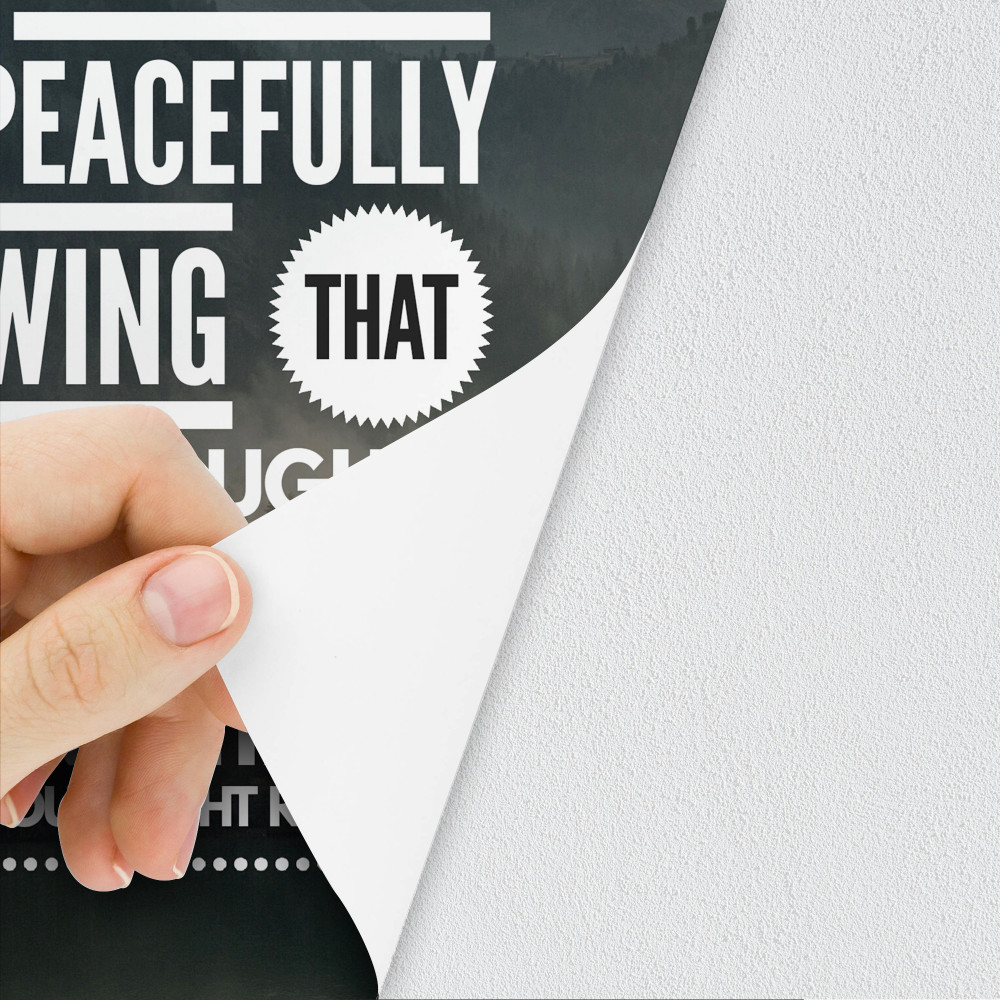 Hand peeling back the corner of an adhesive wall fabric print Hand peeling back the corner of an adhesive wall fabric print